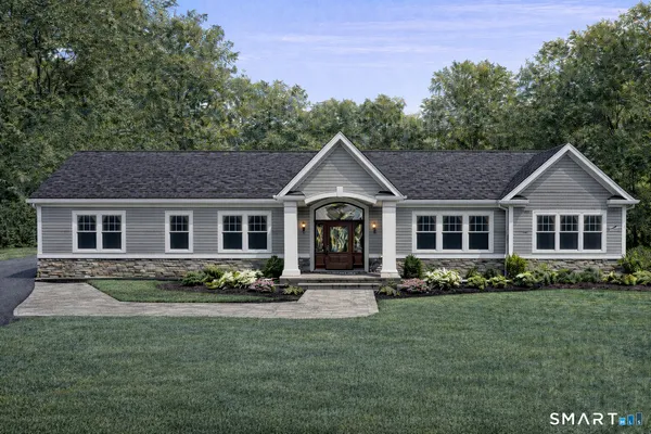a front view of a house with a yard