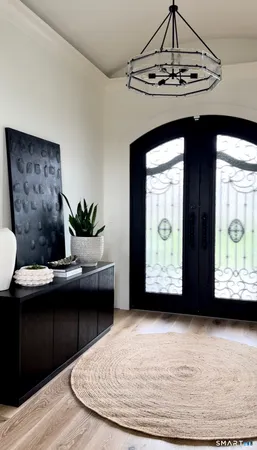 a view of a livingroom with furniture and a floor to ceiling window