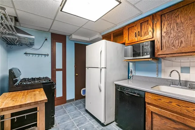 a kitchen with stainless steel appliances granite countertop a refrigerator and a sink