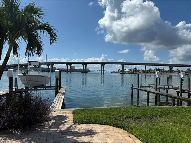 a view of a swimming pool with a bench and lawn chairs