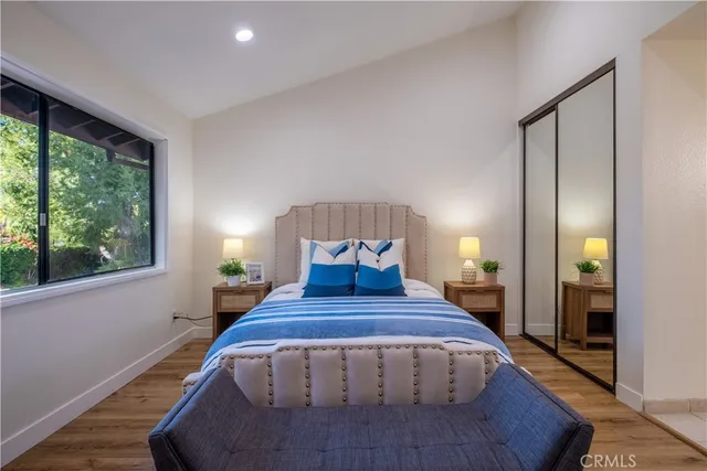 a spacious bedroom with a large bed and a window