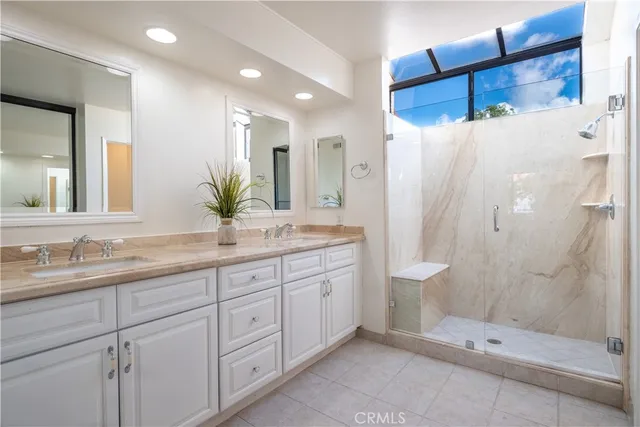 a bathroom with a double vanity sink and a mirror
