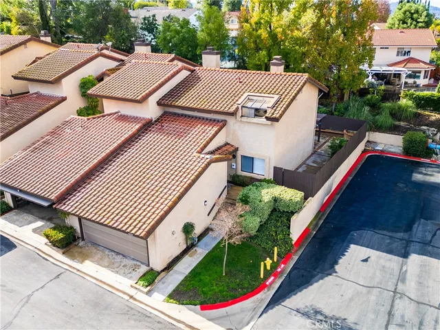 an aerial view of a house with garden space and street view