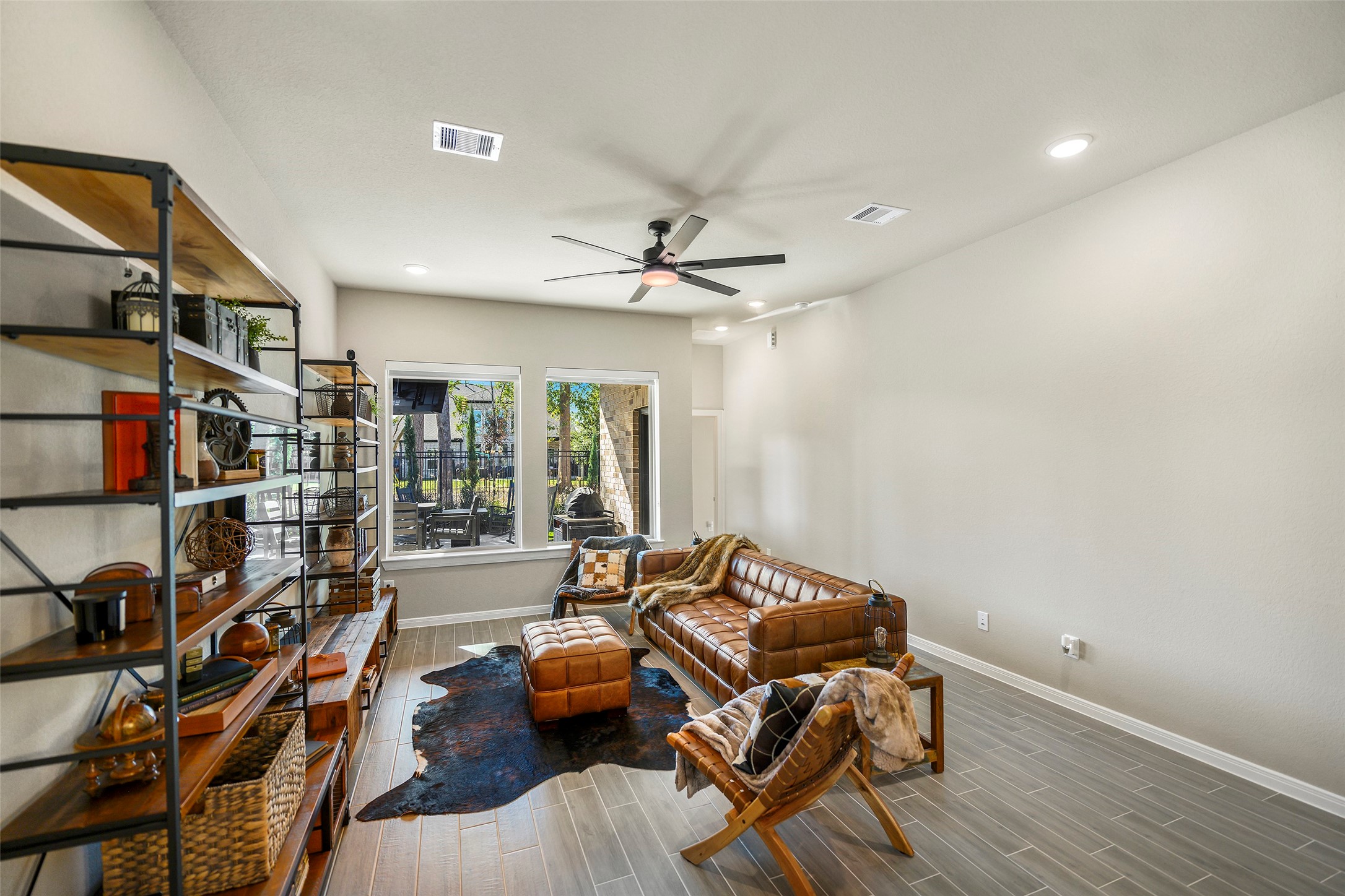 7474 Cattail Fls Lane Porter, TX 77365 - Photo 5 of 46 a living room with furniture a ceiling fan and a rug