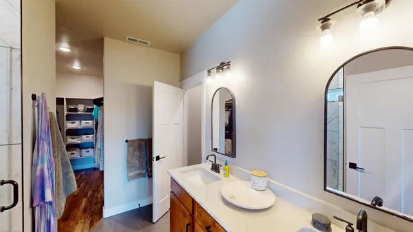 a bed sitting in a bedroom next to a window