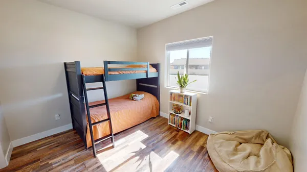 a living room with furniture potted plant and kitchen view