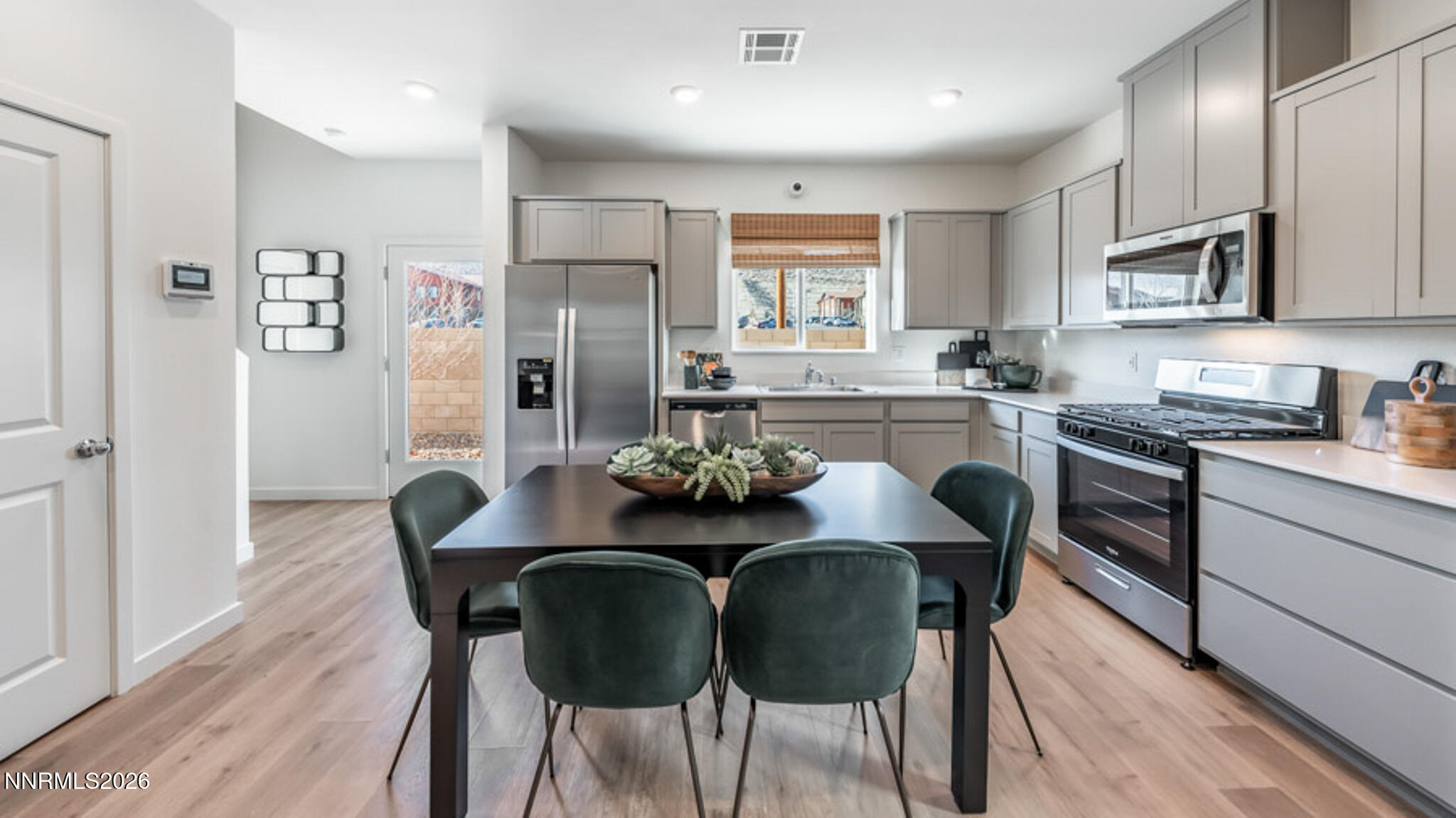 8387 Vermilion Drive Reno, NV 89506 - Photo 7 of 16 a view of a dining room with furniture and wooden floor