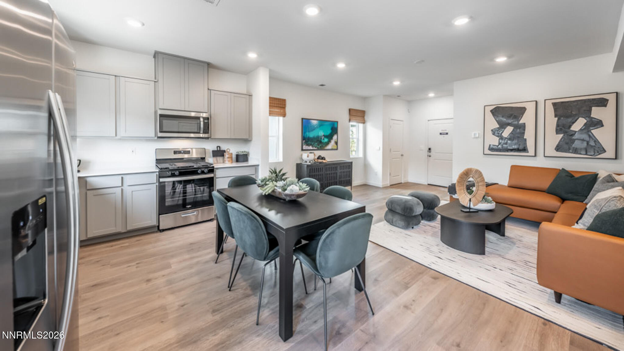 8387 Vermilion Drive Reno, NV 89506 - Photo 8 of 16 a view of a dining room with furniture a kitchen and chandelier