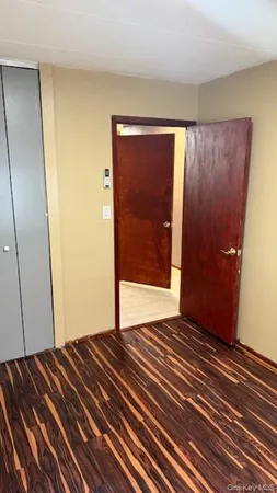 a view of a room with wooden floor and brick wall