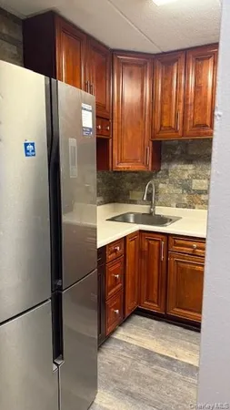 a kitchen with stainless steel appliances granite countertop a refrigerator and a sink