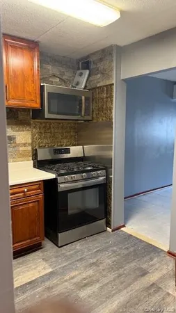 a kitchen with granite countertop a stove and a sink