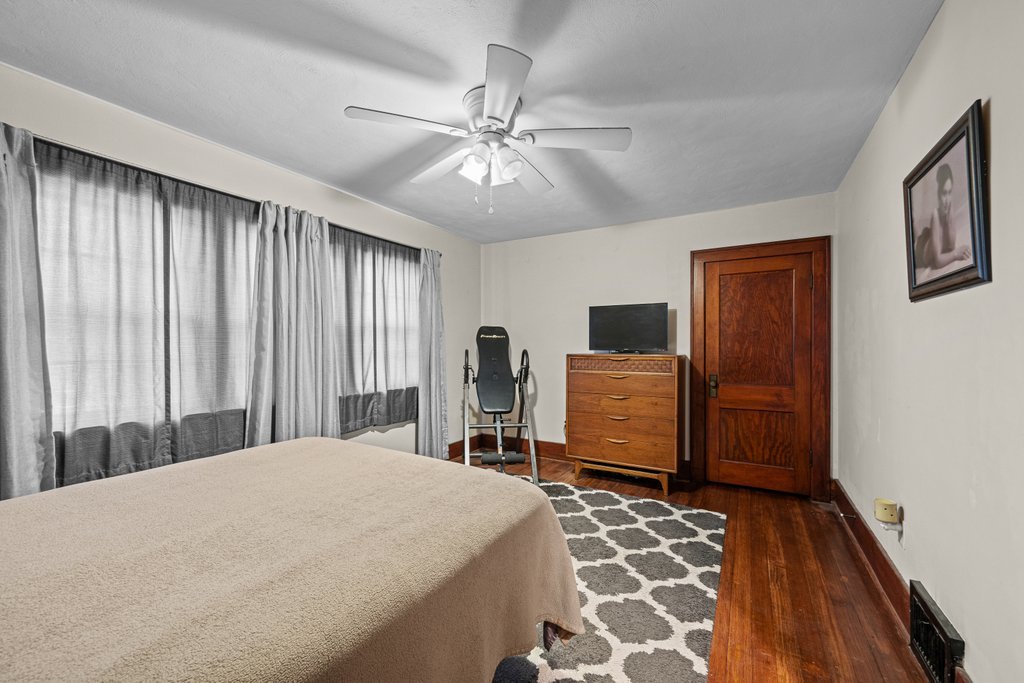 4202 10th Avenue Moline, IL 61265 - Photo 14 of 18 a bedroom with a large bed and a chandelier
