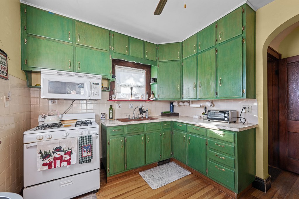 4202 10th Avenue Moline, IL 61265 - Photo 7 of 18 a kitchen with a sink and cabinets