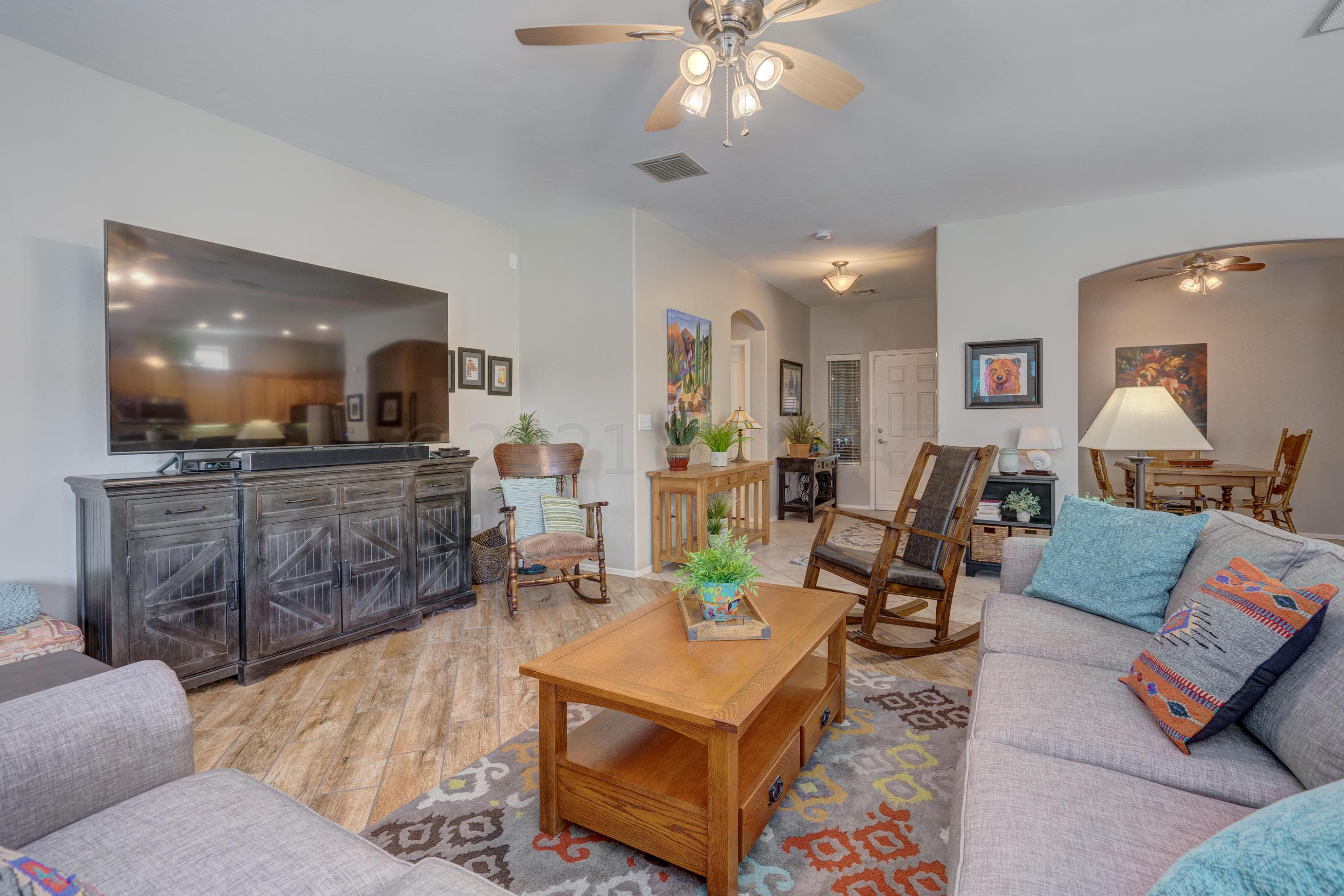 3639 East Northern Dancer Road Tucson, AZ 85739 - Photo 6 of 48 a living room with furniture and a flat screen tv