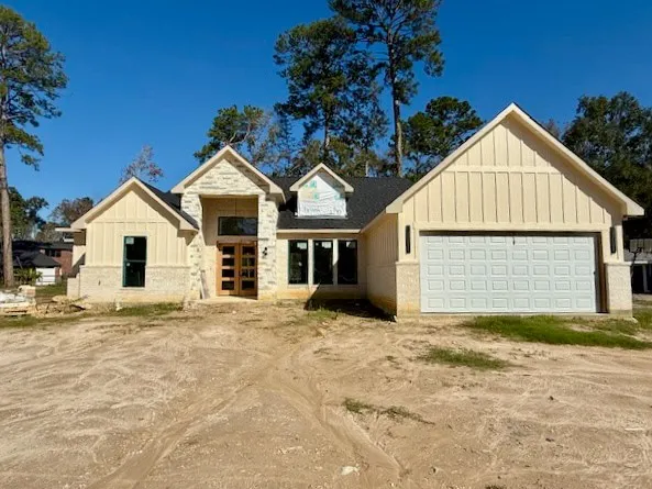 a view of a house with a yard and garage