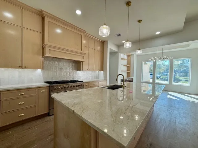 a kitchen with sink refrigerator and cabinets