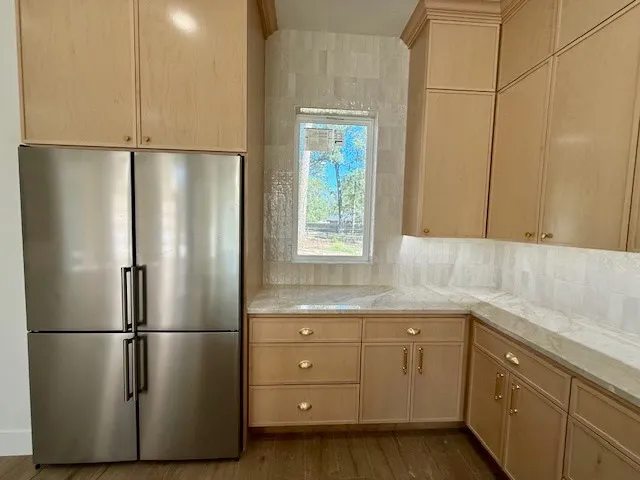 a kitchen with a refrigerator sink and cabinets