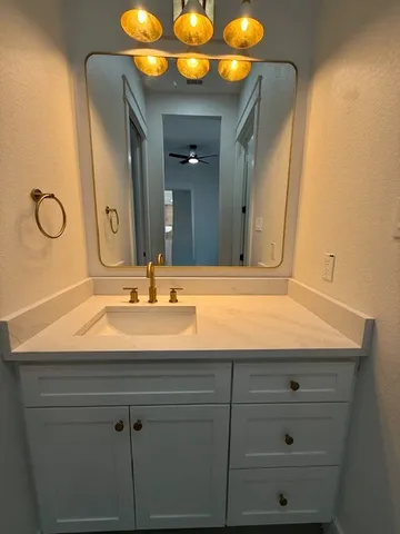 a bathroom with a sink vanity and a mirror