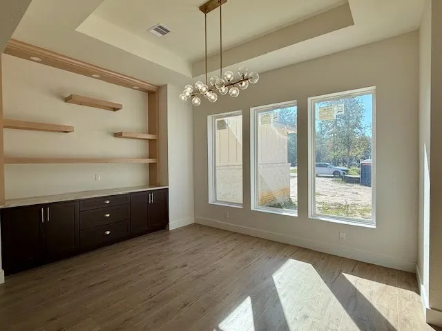 a view of a room with large windows and cabinet