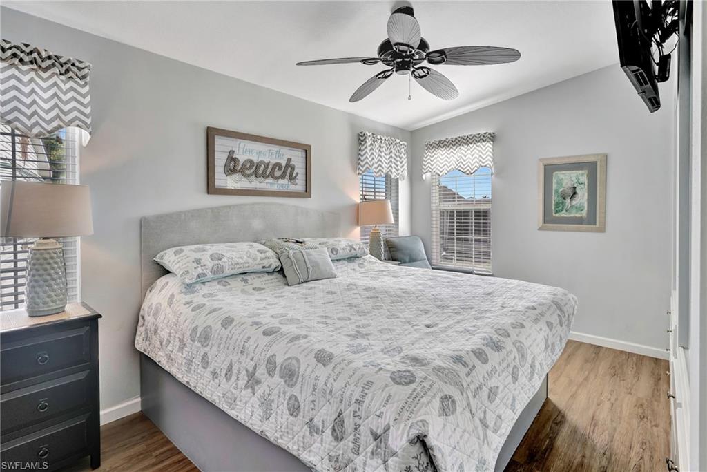10709 Roseate Spoonbill Circle Estero, FL 33928 - Photo 12 of 32 a bedroom with a large bed and a window