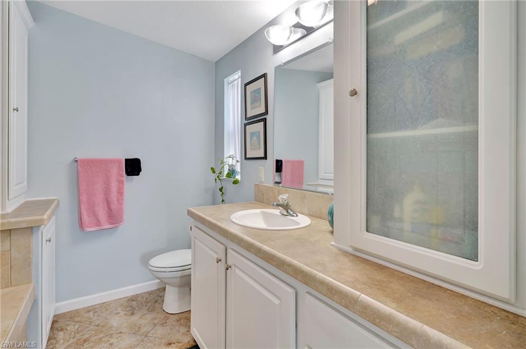 10709 Roseate Spoonbill Circle Estero, FL 33928 - Photo 14 of 32 a bathroom with a sink toilet and shower