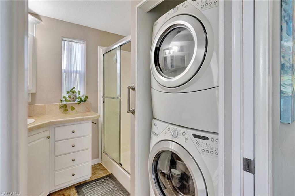 10709 Roseate Spoonbill Circle Estero, FL 33928 - Photo 16 of 32 a view of a hallway with washer and dryer