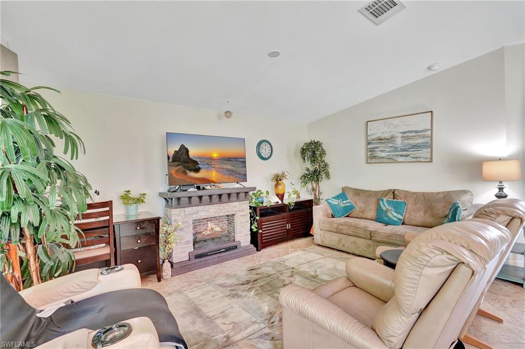 10709 Roseate Spoonbill Circle Estero, FL 33928 - Photo 3 of 32 a living room with furniture and a flat screen tv