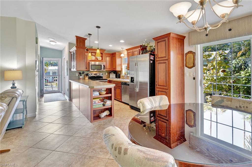 10709 Roseate Spoonbill Circle Estero, FL 33928 - Photo 5 of 32 a living room with furniture a chandelier and a dining table