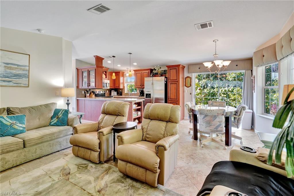 10709 Roseate Spoonbill Circle Estero, FL 33928 - Photo 6 of 32 a living room with furniture and a large window