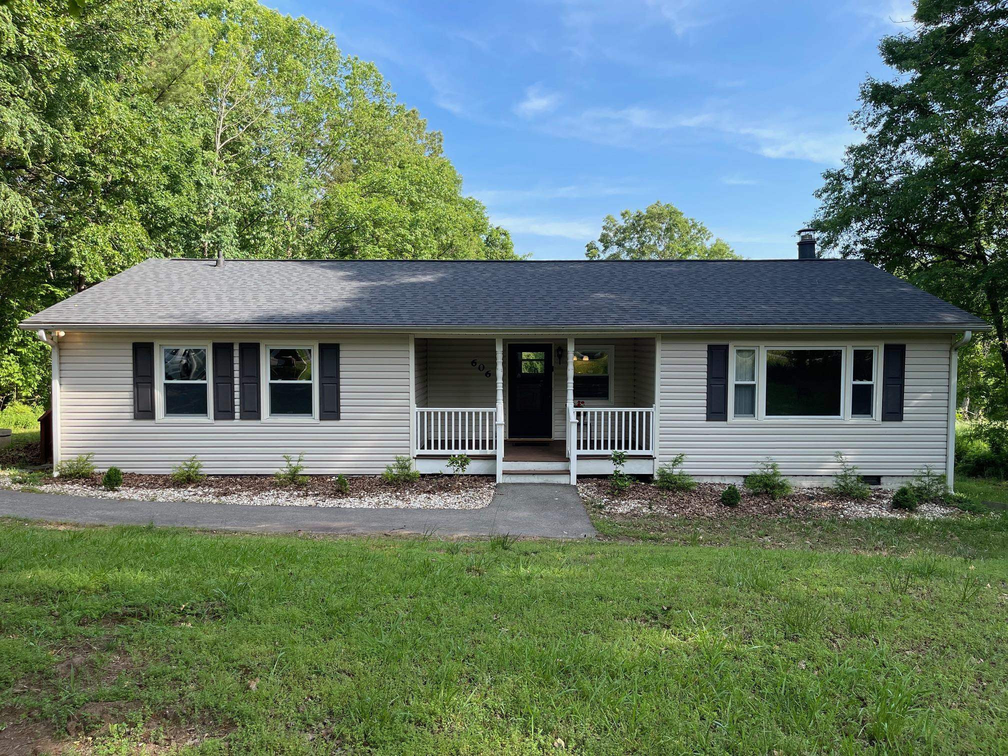 606 Infinity Road Durham, NC 27712 - Photo 1 of 30 a front view of a house with a garden