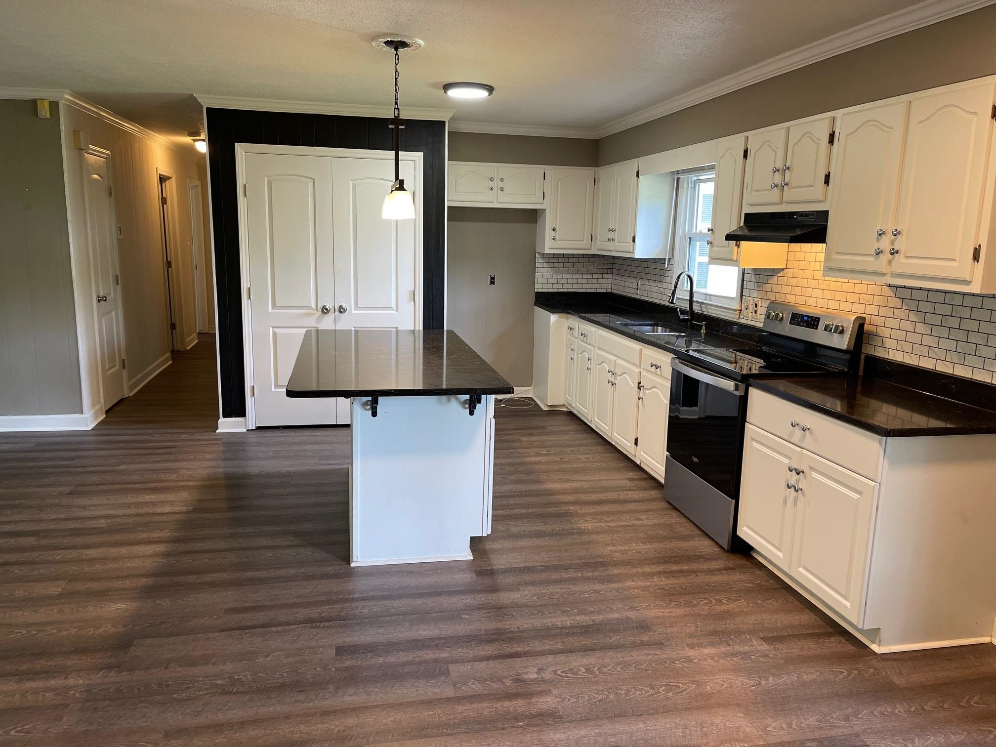 606 Infinity Road Durham, NC 27712 - Photo 11 of 30 a large kitchen with stainless steel appliances granite countertop a stove a sink and white cabinets