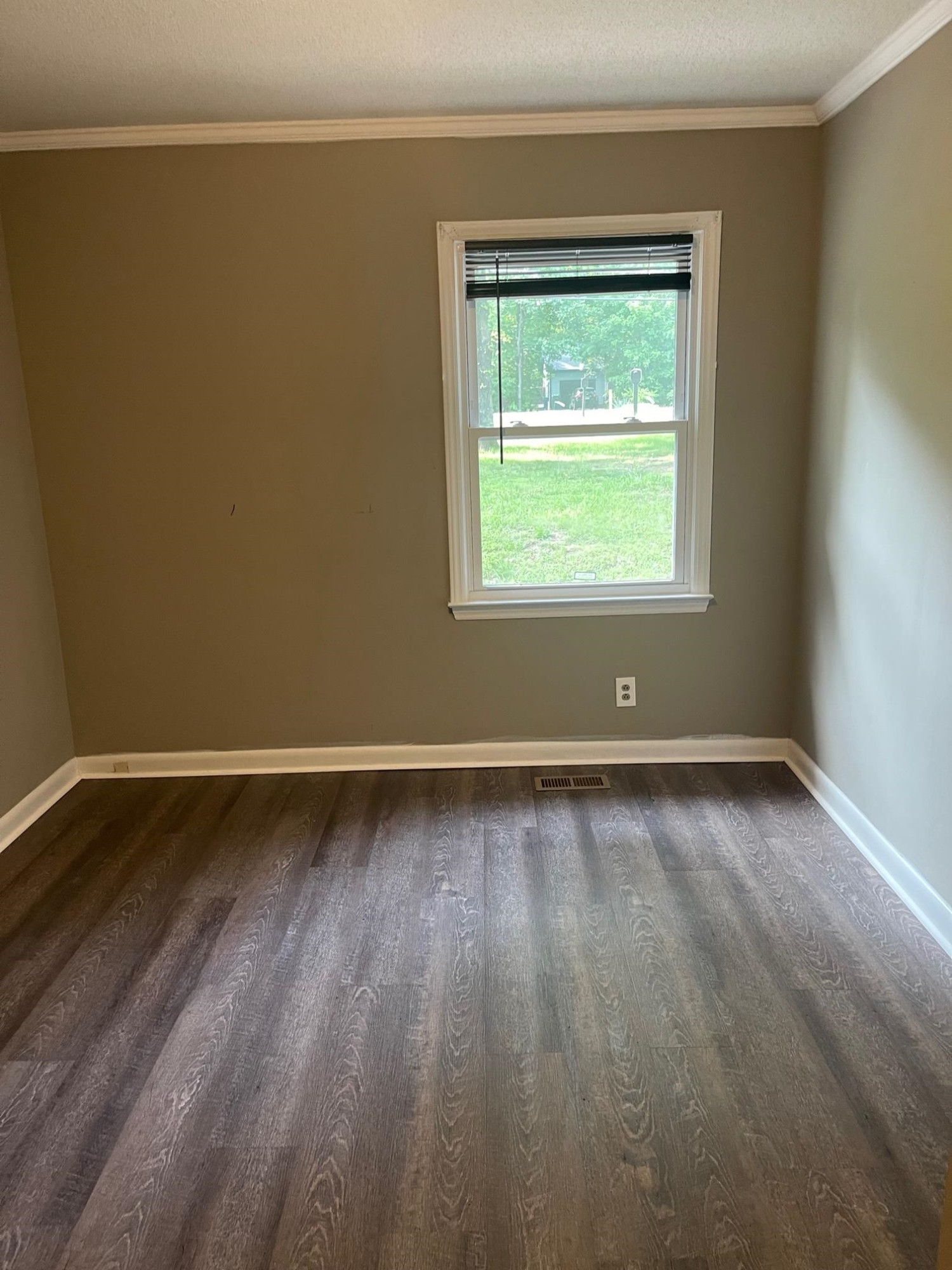 606 Infinity Road Durham, NC 27712 - Photo 16 of 30 a view of an empty room with wooden floor and a window