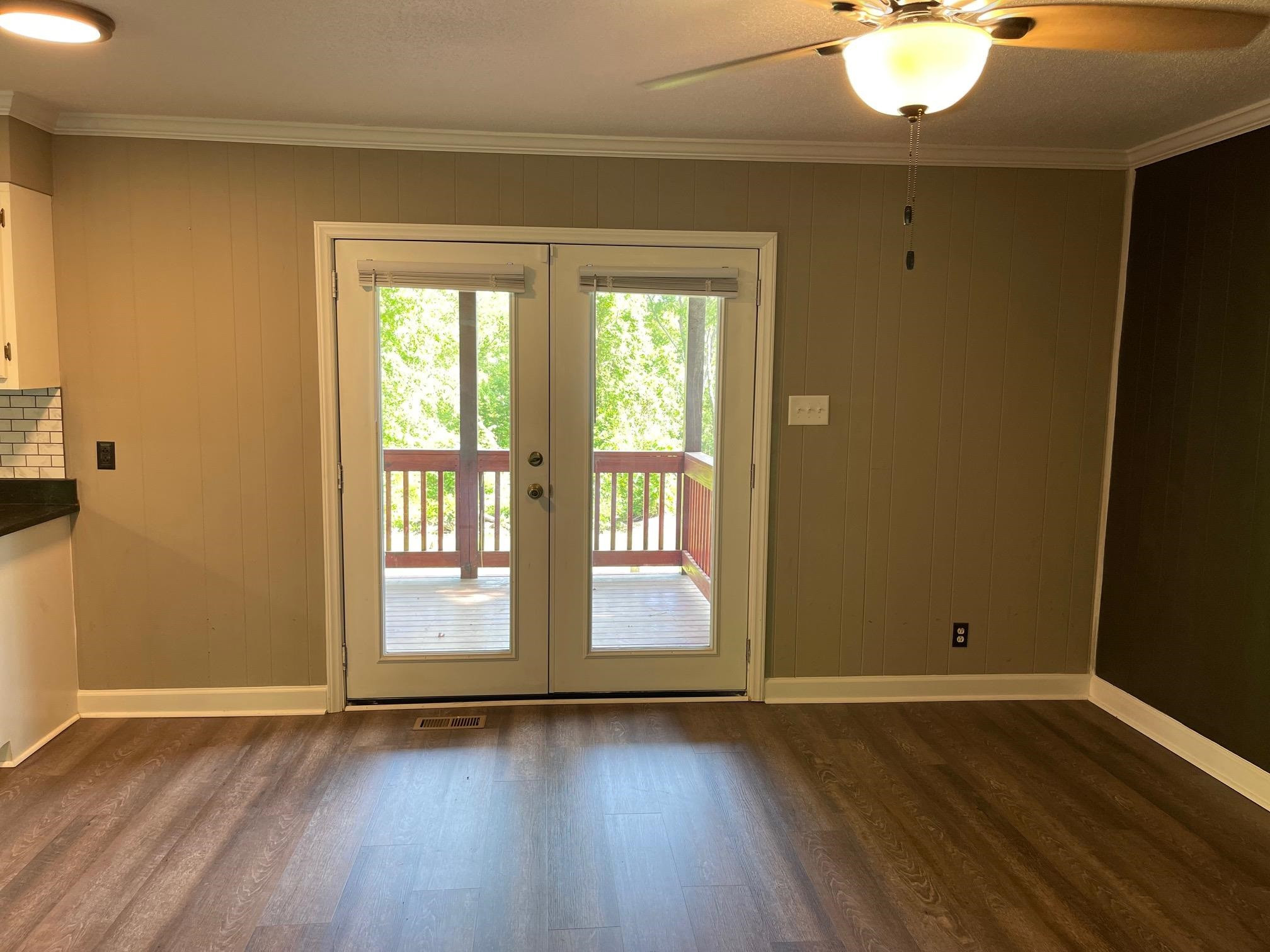 606 Infinity Road Durham, NC 27712 - Photo 4 of 30 a view of an empty room with wooden floor and a window