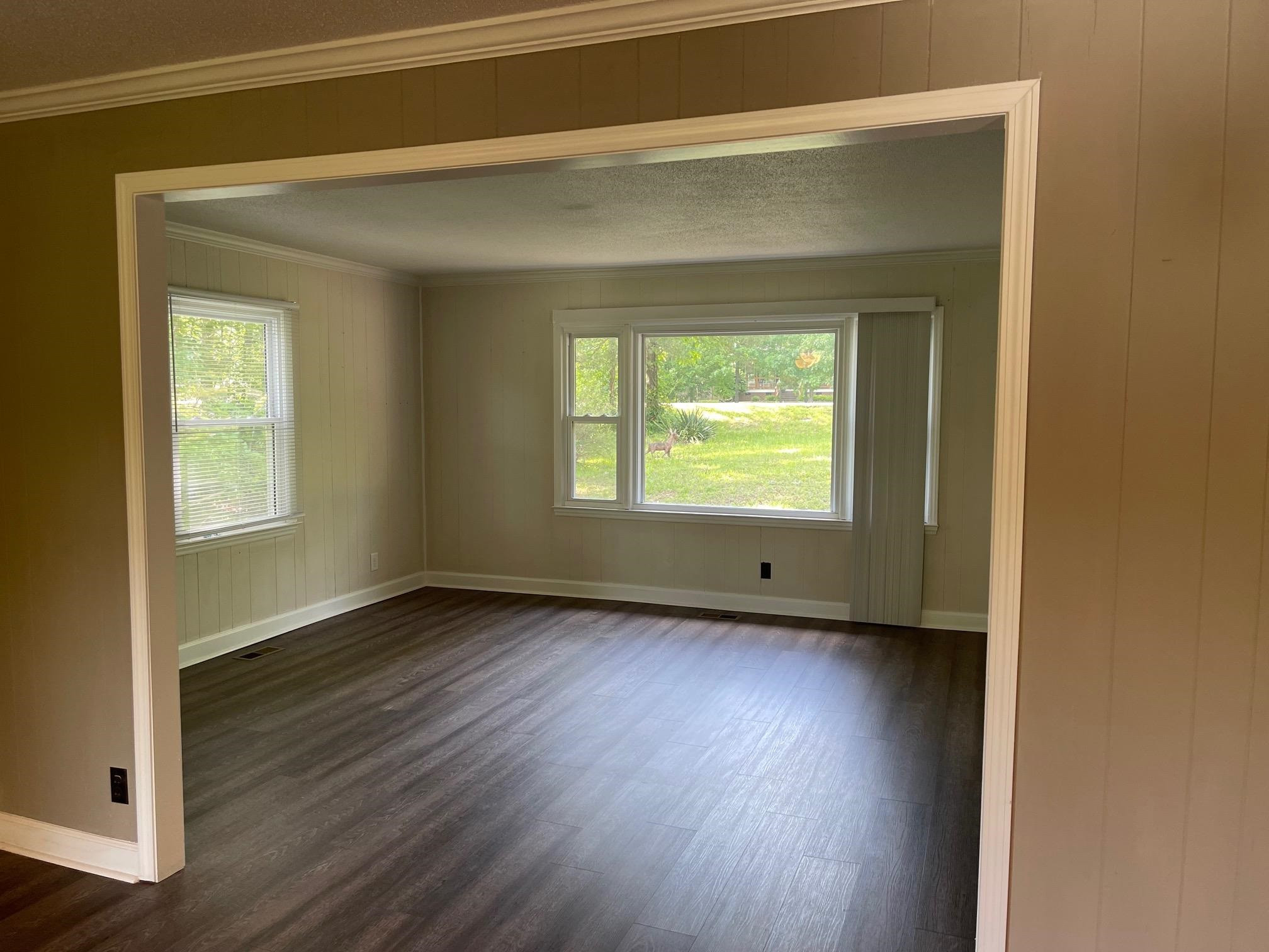 606 Infinity Road Durham, NC 27712 - Photo 7 of 30 an empty room with wooden floor and a window