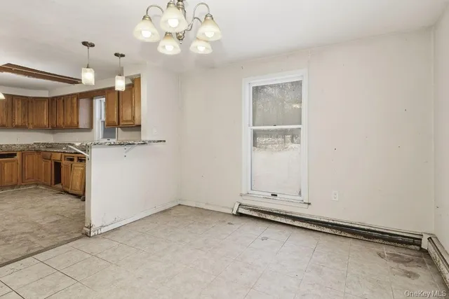 an empty room with chandelier fan