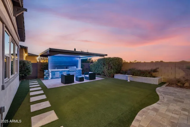 a view of a patio with couches table and chairs with wooden floor and a yard