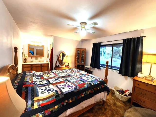 a view of a house with pool and chairs under an umbrella