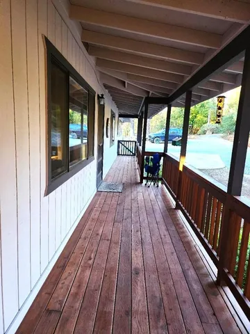 a view of balcony with wooden floor