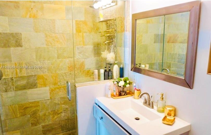 2681 North Flamingo Road, Unit 2602S Sunrise, FL 33323 - Photo 7 of 18 a bathroom with a sink mirror and a shower