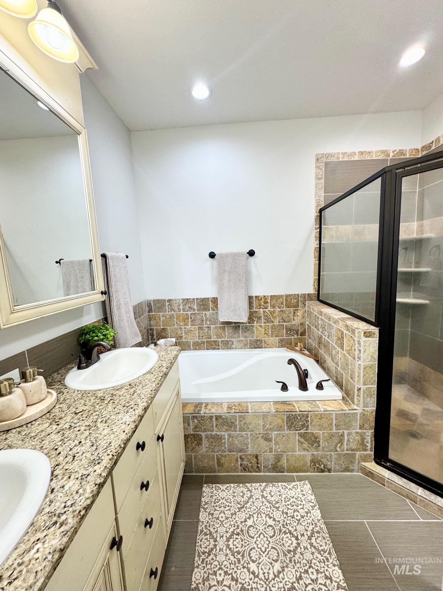 650 Lochsa Loop Heyburn, ID 83336 - Photo 13 of 26 Full bathroom featuring a bath, a stall shower, double vanity, and recessed lighting