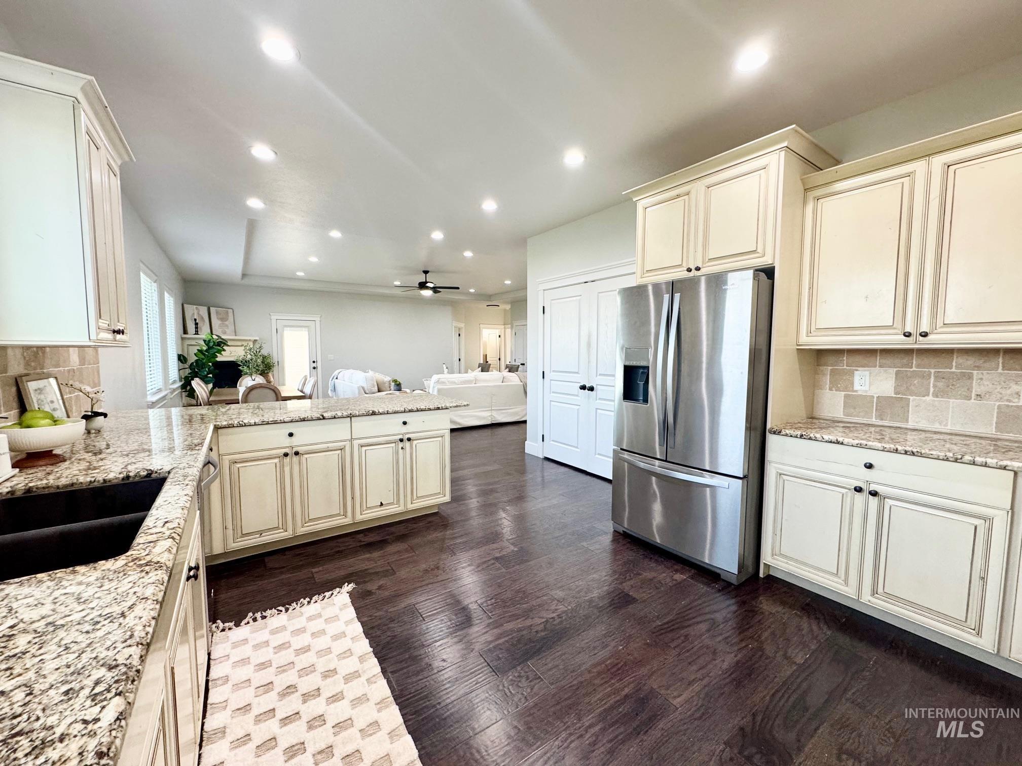 650 Lochsa Loop Heyburn, ID 83336 - Photo 10 of 26 Kitchen with tasteful backsplash, a peninsula, stainless steel fridge, recessed lighting, and light stone counters