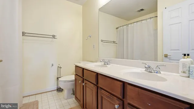 a bathroom with a toilet mirror and vanity