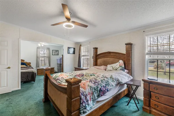 a bedroom with a bed and window