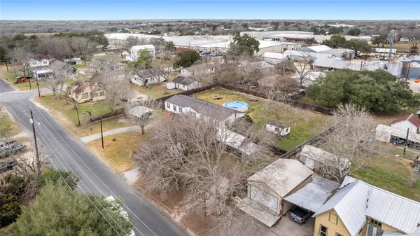 an aerial view of a house with a yard