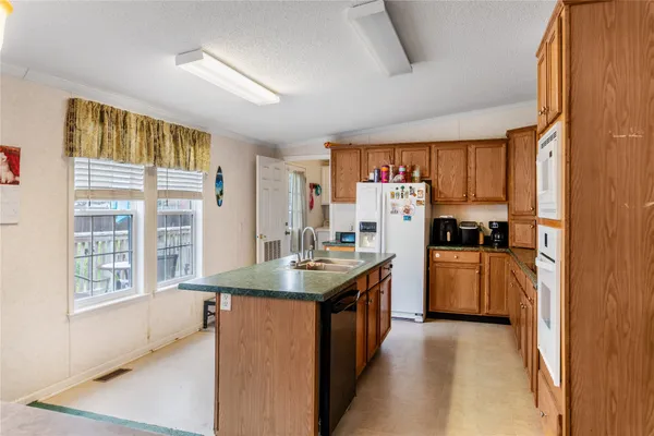 a kitchen with refrigerator and window