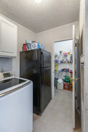 a kitchen with a refrigerator and a sink