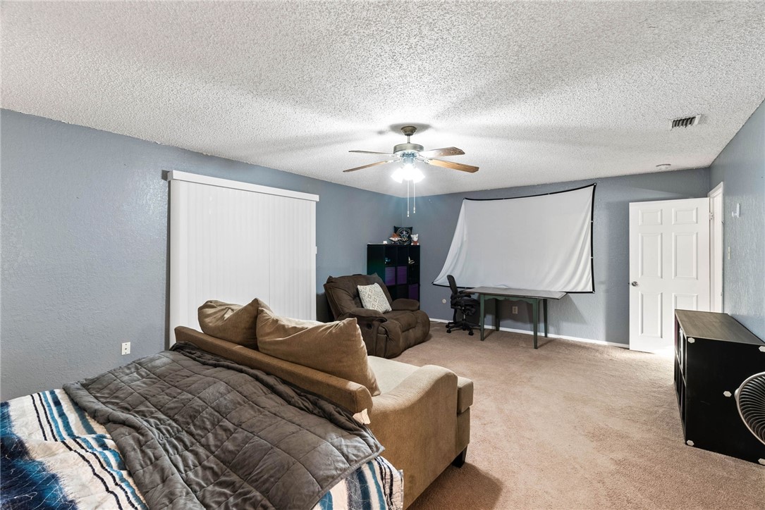 4114 Beard Drive Corpus Christi, TX 78413 - Photo 19 of 40 a bed room with a bed furniture and a ceiling fan