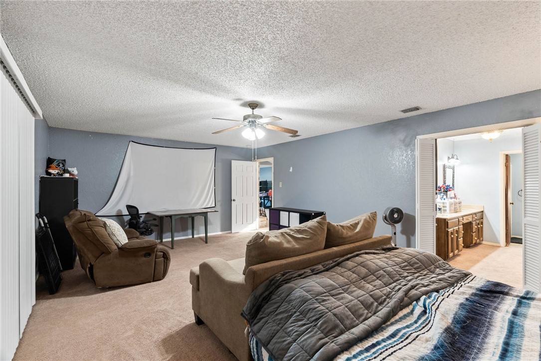 4114 Beard Drive Corpus Christi, TX 78413 - Photo 20 of 40 a bed room with a bed and a chandelier