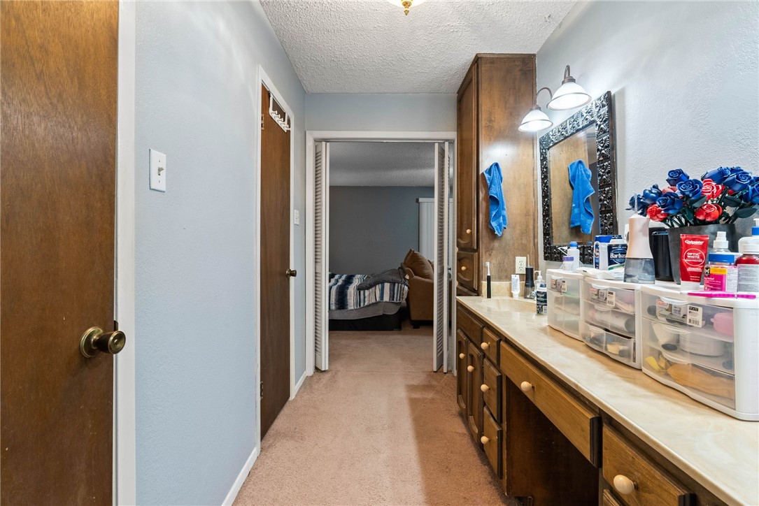 4114 Beard Drive Corpus Christi, TX 78413 - Photo 22 of 40 a en suite bathroom with a double vanity sink a large mirror and a shower