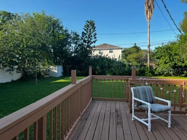 a view of balcony with wooden floor and outdoor seating